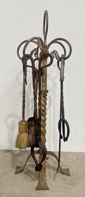 Lot 313 - An ornate wrought iron fireside companion set...