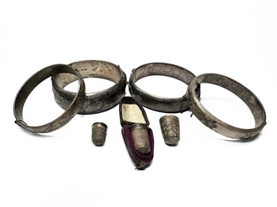 Lot 585 - Four twentieth-century silver bracelets, three...