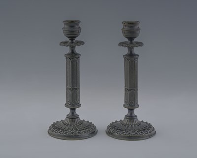 Lot 617 - A pair of bronze candlesticks, mid-19th...