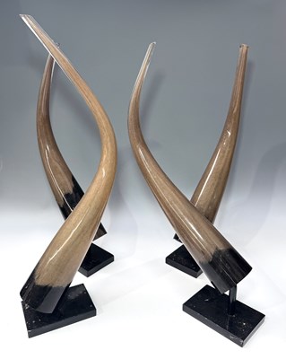 Lot 65 - Four blown glass buffalo horns on metal mounts...