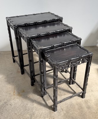 Lot 769 - A nest of four black lacquered simulated...