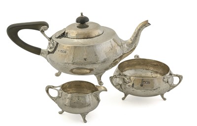 Lot 230 - A George V Arts & Crafts silver three-piece...