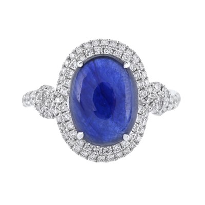 Lot 30 - A sapphire cabochon and brilliant-cut diamond cluster ring