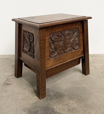 Lot 739 - An Arts & Crafts carved, quarter-sawn oak...