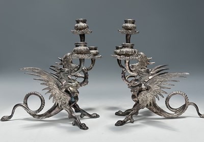 Lot 248 - A pair of plated candelabra shaped as a hyras,...