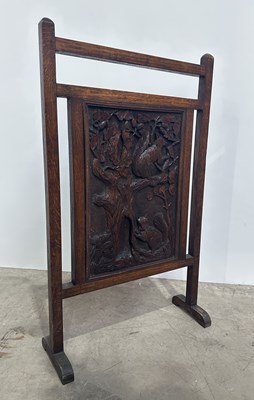 Lot 735 - A carved oak Arts & Crafts fire screen with...