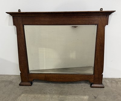 Lot 720 - An Arts and Crafts, oak mirror in the Liberty...