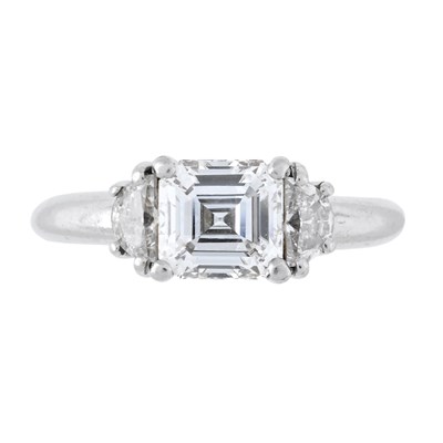 Lot 187 - A platinum emerald-cut and fancy-cut diamond three stone ring, by Hirsh