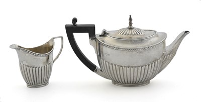 Lot 250 - An Edwardian silver teapot and milk jug, by...