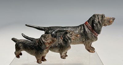 Lot 111 - A figure group of cast metal, coal-painted...