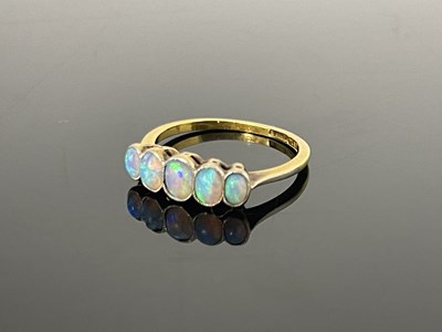 Lot 189 - An 18ct gold five stone opal ring, with bezel...