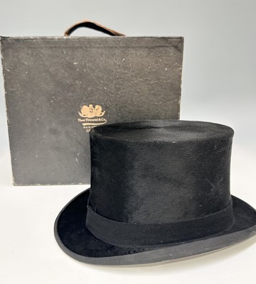 Lot 309 - A Moss Bros top hat, black, with quilted tan...