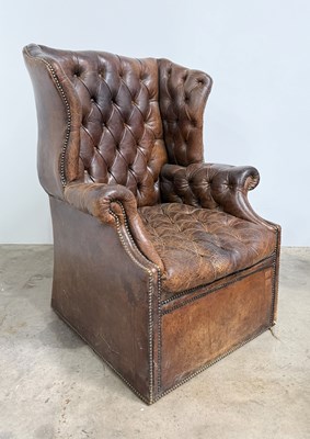 Lot 731 - A full button wingback armchair in the style...