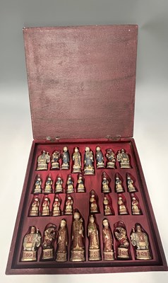 Lot 342 - A cast resin cased chess set with integrated...