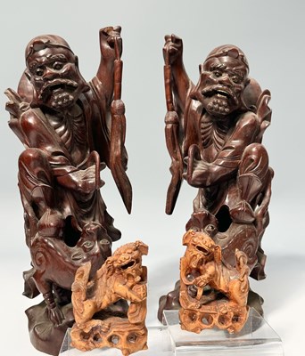 Lot 97 - A pair of carved Chinese hardwood figures,...