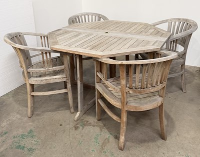 Lot 831 - A Cotswold teak dining table and four chairs:...
