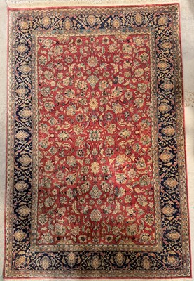 Lot 705 - A hand-knotted Persian wool rug/carpet,...