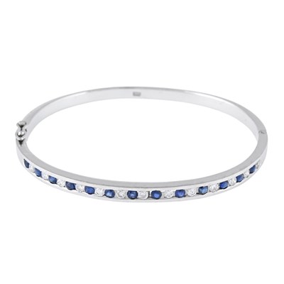 Lot 29 - A sapphire and brilliant-cut diamond hinged bangle bracelet