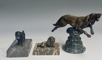 Lot 372 - Three cast metal dog figurines on hardstone...