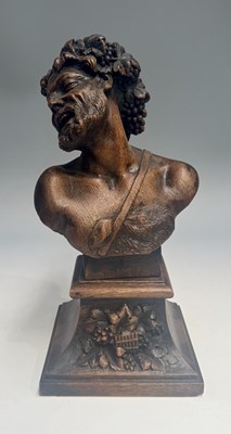 Lot 381 - A carved wood Bacchanalian bust, depicted with...