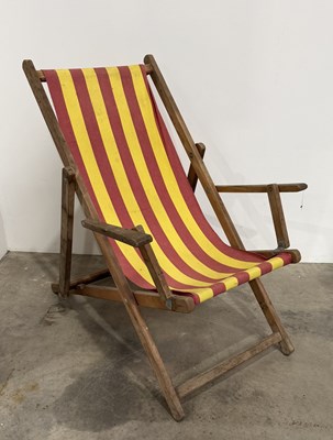 Lot 830 - A red and yellow striped canvas and wooden...