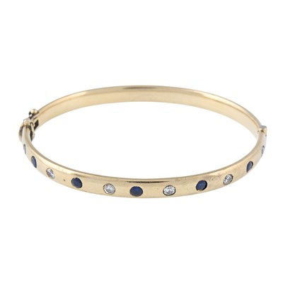 Lot 192 - A 9ct gold brilliant-cut diamond and sapphire hinged bangle