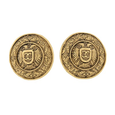 Lot 334 - Chanel, a pair of round vintage CC logo crest shield clip-on earrings.