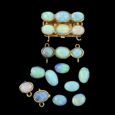 Lot 283 - An opal clasp, collet mounted opal jewellery components and loose opal cabochons