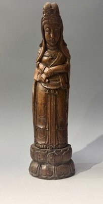 Lot 148 - A Chinese carved wood deity figure of Guanyin,...