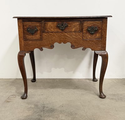 Lot 436 - A late 18th century quarter sawn oak lowboy: a...