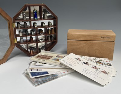 Lot 188 - A collection of thimbles in a display case,...
