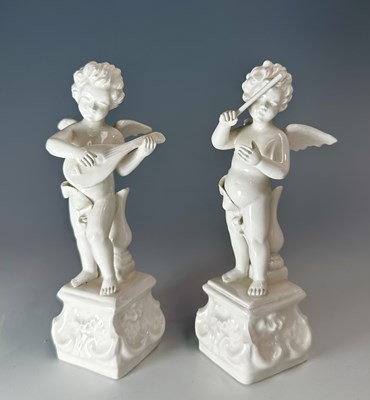 Lot 62 - A pair of finely modelled white-glazed putti...