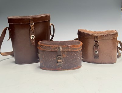 Lot 194 - Three pairs of binoculars in leather cases: to...