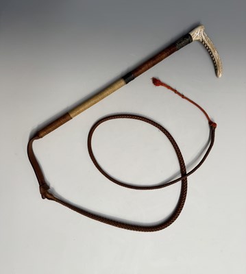 Lot 193 - A braided leather hunting whip, carved antler...