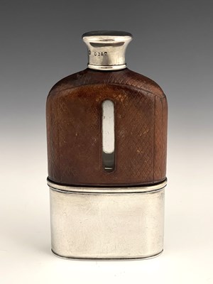 Lot 24 - A Victorian hip flask, the glass body mounted...