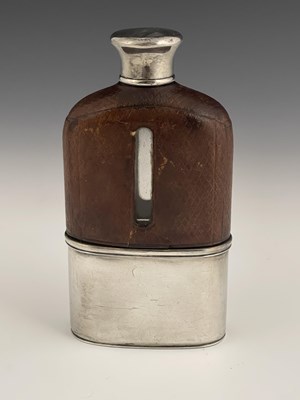 Lot 24 - A Victorian hip flask, the glass body mounted...