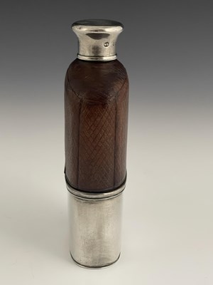 Lot 24 - A Victorian hip flask, the glass body mounted...