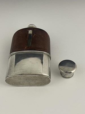 Lot 24 - A Victorian hip flask, the glass body mounted...