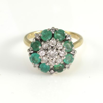 Lot 196 - An 18ct gold emerald and diamond set cluster...