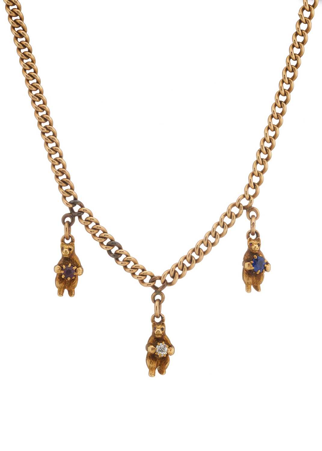 Lot 4 - An early 20th century 15ct gold curb-link necklace, with bear charms