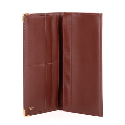 Lot 290 - Cartier, a long Bordeaux Bifold wallet,...