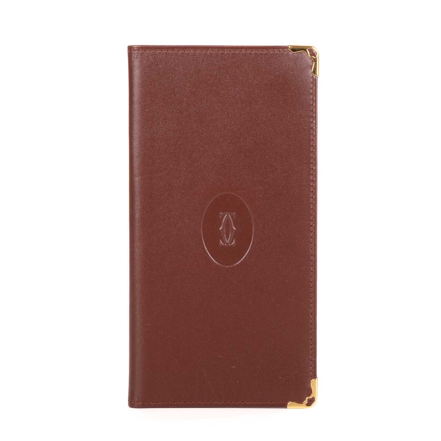 Lot 292 - Cartier, a long Bordeaux Bifold wallet,...