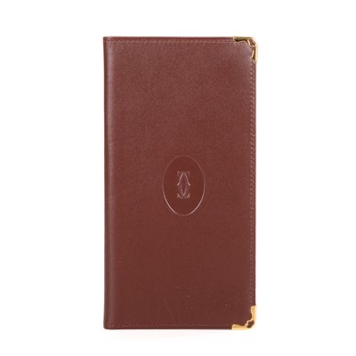 Lot 292 - Cartier, a long Bordeaux Bifold wallet,...