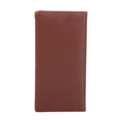 Lot 292 - Cartier, a long Bordeaux Bifold wallet,...