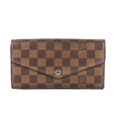 Lot 409 - Louis Vuitton, a damier ebene Sarah wallet,...