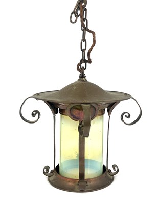 Lot 181 - An Arts and Crafts copper and opalescent glass...