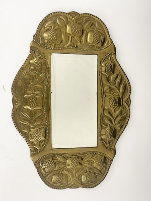 Lot 148 - An Arts and Crafts brass mirror, in the...